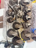 Group of swivel caster wheels with steel brackets on rack