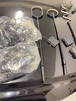 Two bagged string light sets and three metal stake lights with battery packs