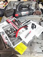 Spiral saw in case with accessories and manuals visible