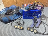 Full lot showing duffel bag, hoses, consoles, boots, regulators, masks