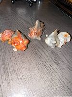 Three agate koi fish figurines on tabletop