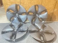 Front view of four Tesla wheel covers stacked upright