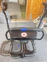 Front view of U-Step II walker showing seat, handles and wheels