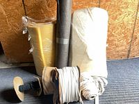 Overall lot showing yellow foam roll, white foam roll, grey lining roll, zipper and cord spools