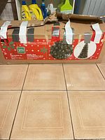 Holiday Joy carton containing tree, taped closed