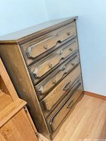 Front view of dresser showing five drawers and finish