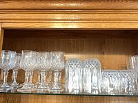Full shelf view showing stemmed glasses, tall tumblers, short tumblers