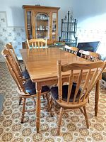 table with chairs, oak china cabinet and baker's rack in background