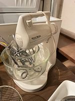 West Bend mixer on base with glass bowl and metal attachments visible