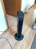 Full view of the Westinghouse tower fan on base with power cord