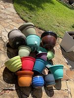 Group of assorted pots on stone patio