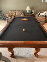 Full view of Brunswick pool table with balls racked