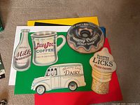 All five retro diner themed wall signs arranged on colored boards