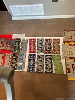 Assorted colored metal bridge boards laid out on floor showing different numbers and colors