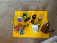 Overhead view of all ten garden/home decor accent pieces on yellow board