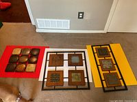 All three decorative tile panels laid out side by side