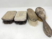 Four Birks sterling silver-backed brushes front view