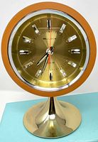 Front view of Bulova orb clock showing dial, bezel, and tulip base