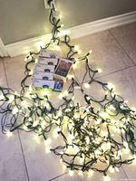 Lit warm-white string lights and boxed sets on floor