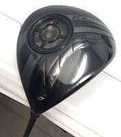 Top view of Cobra King LTD Black driver head showing carbon crown, weight port, scratches