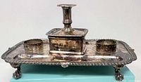 overall front view showing inkstand platform, candle holder, inkwell recesses, feet