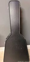 Full view of closed black hard shell guitar case