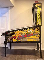 Left side view of Data East Last Action Hero pinball cabinet showing artwork and legs