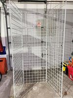 Three hinged light gray steel gridwall panels standing in U-shape