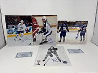 Overview showing all four signed photos and both COA cards