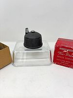 Pencil pointer head on clear stand with box halves visible