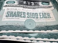 Stack showing Canadian Westinghouse certificate top portion with green border and embossed seal