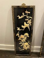 Full view of black lacquer wall panel showing inlaid birds and flowers
