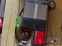 Top view showing entire inflator, gauge, light lens, air hose, power cord