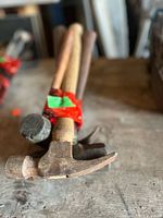 Bundle of four hammers tied together showing heads and handles
