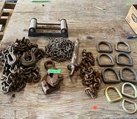 Entire lot on table: roller fairlead, chains, hooks, D-rings