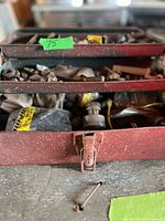 Open toolbox showing trays full of assorted hardware