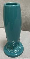 Front view of turquoise bud vase showing overall shape and color