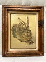 Full view of framed rabbit print in wood frame