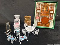 Group shot of all miniature furniture including boxed wood set and loose metal pieces
