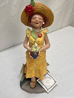 Full view of Lucille figurine with tag