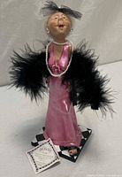 Full view of Vivian figurine on base with tag