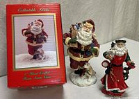 Both Santa figurines with box visible