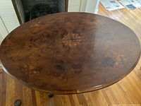 Top view showing oval shape and inlaid veneer pattern