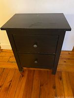 front view of black bedside table with two drawers