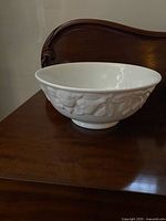Side view of white ceramic bowl on wooden surface