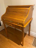 Full view of wooden roll-top desk closed