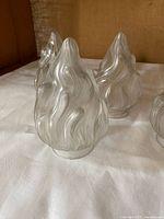 Front view of two frosted glass flame lampshades