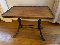 Full view of wooden side table, showing top and base