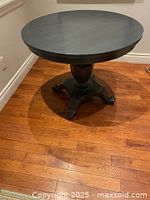 Full view of black round pedestal table