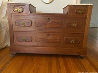 Front view showing drawers and brass pulls